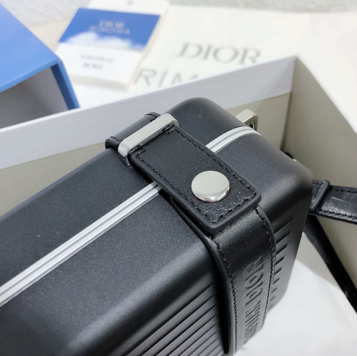 D*or and rimowa black trunk