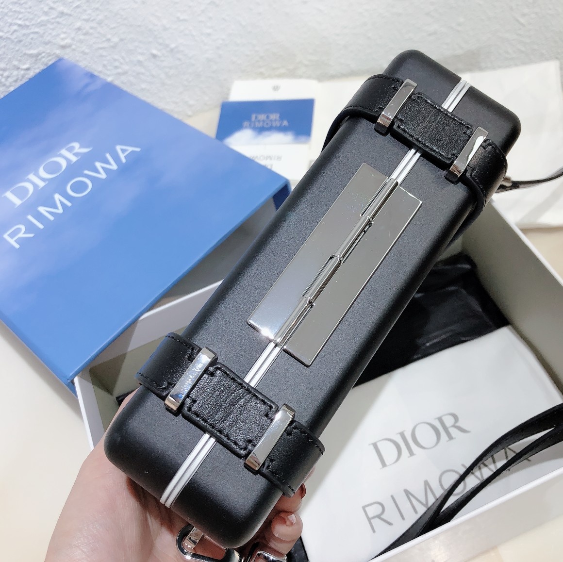 D*or and rimowa black trunk