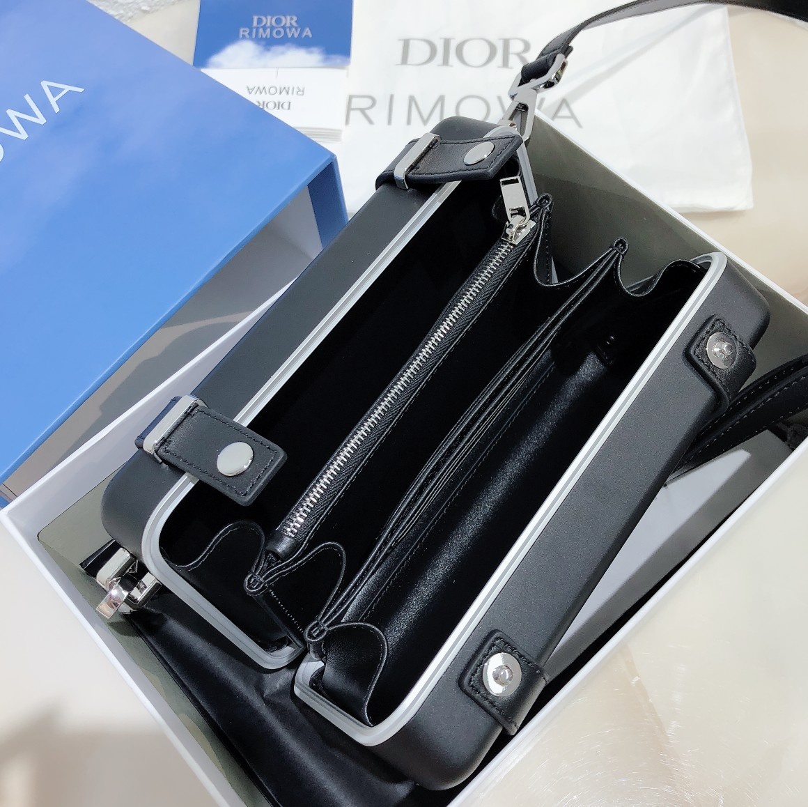 D*or and rimowa black trunk