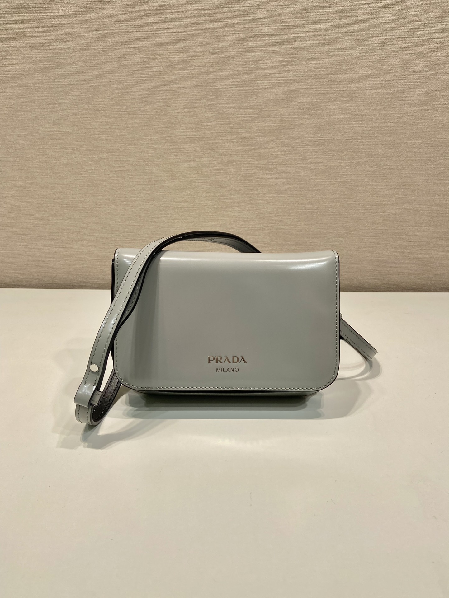 Pra*a brushed leather mini-bag with shoulder strap