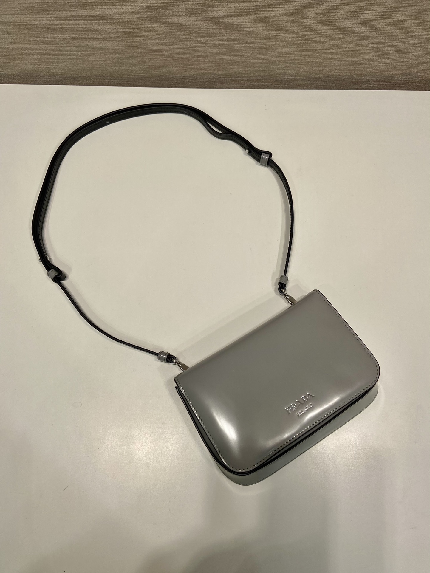 Pra*a brushed leather mini-bag with shoulder strap