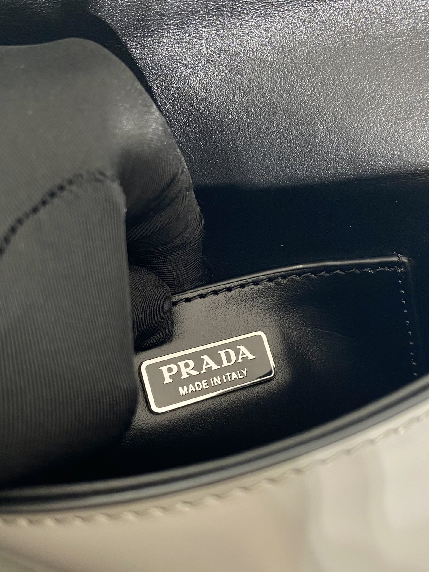Pra*a brushed leather mini-bag with shoulder strap