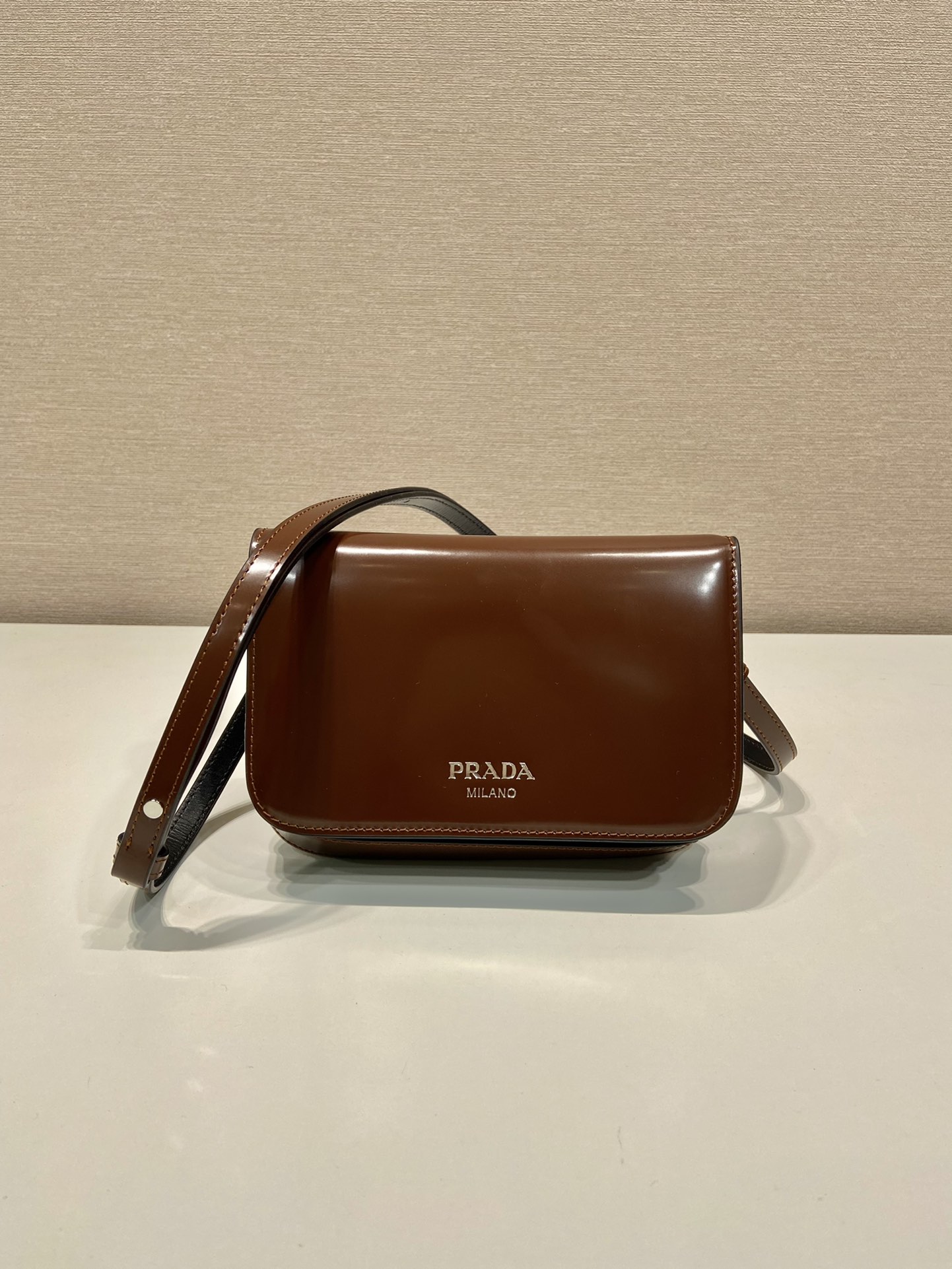 Pra*a brushed leather mini-bag with shoulder strap