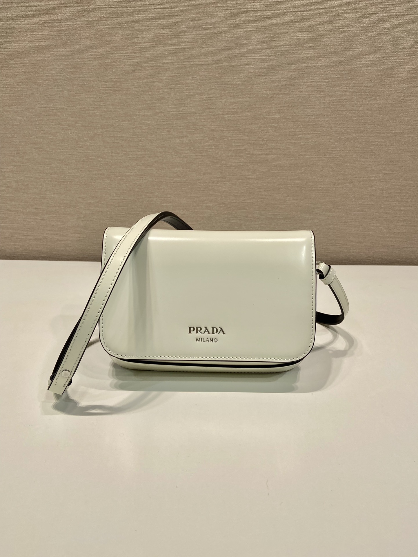 Pra*a brushed leather mini-bag with shoulder strap