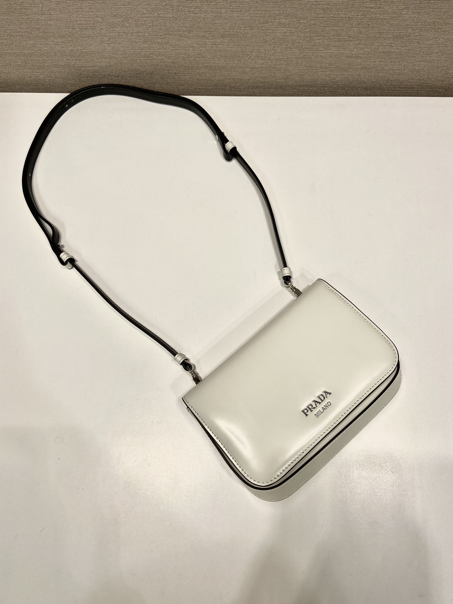 Pra*a brushed leather mini-bag with shoulder strap