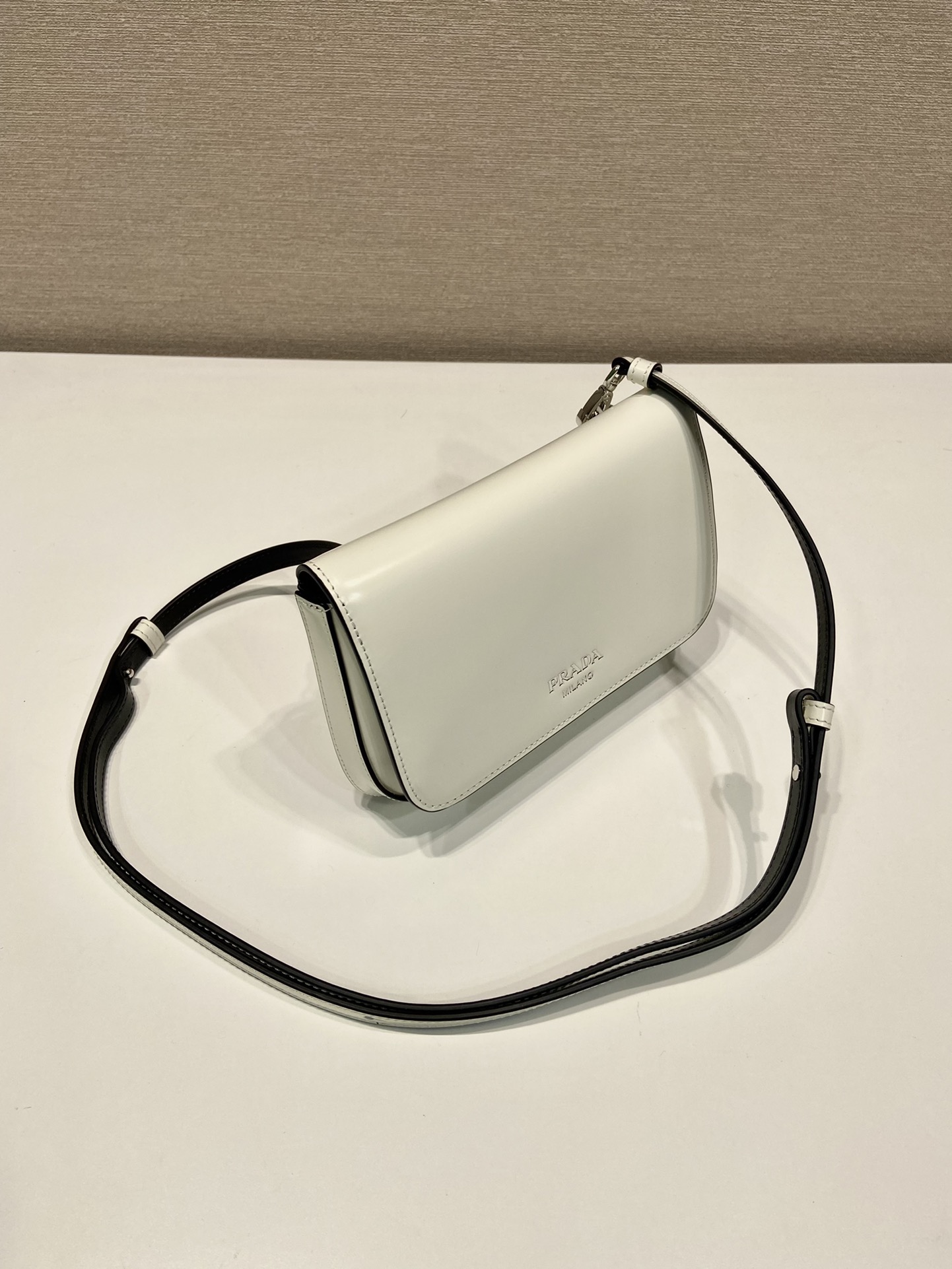 Pra*a brushed leather mini-bag with shoulder strap