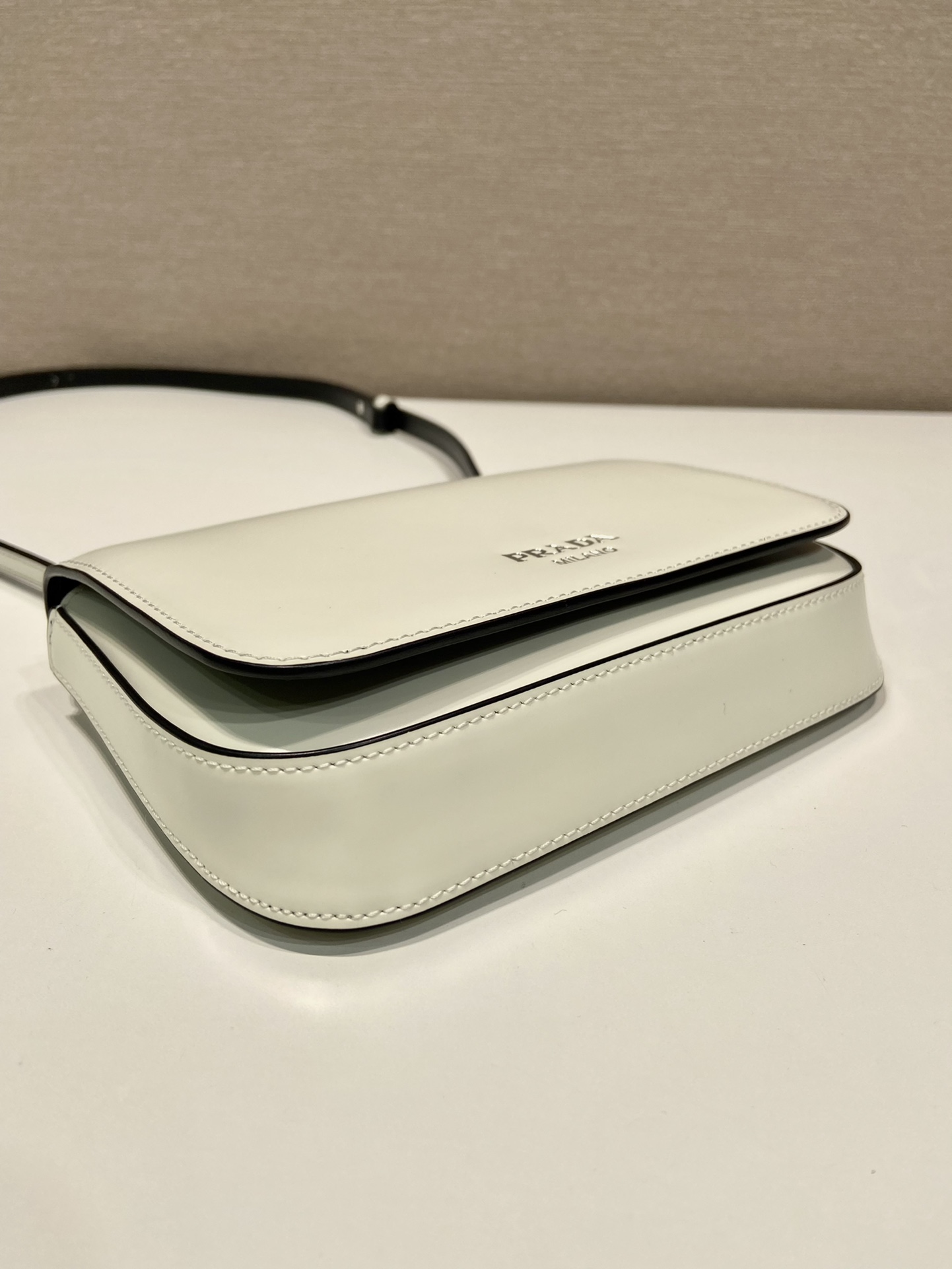 Pra*a brushed leather mini-bag with shoulder strap