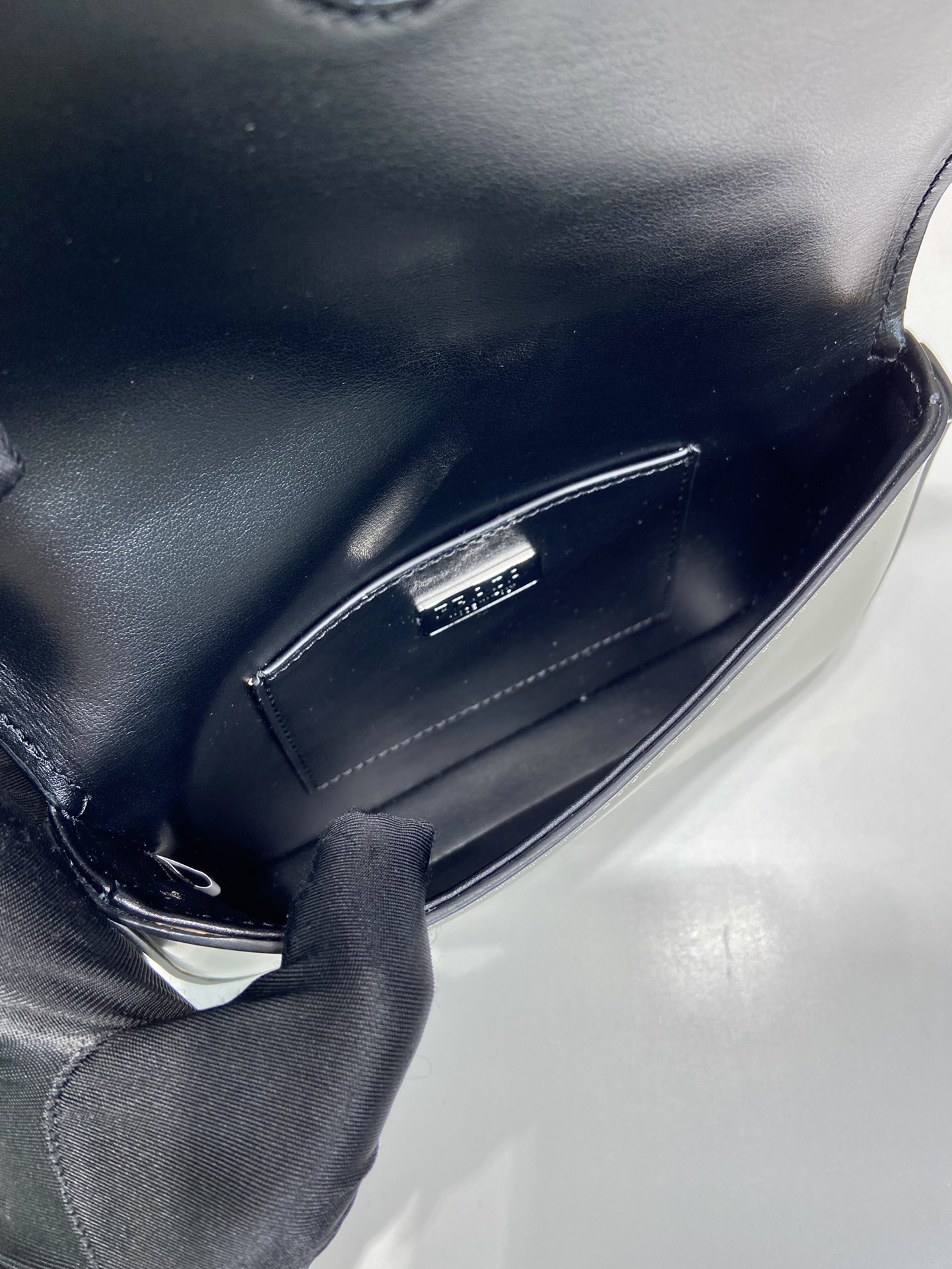 Pra*a brushed leather mini-bag with shoulder strap