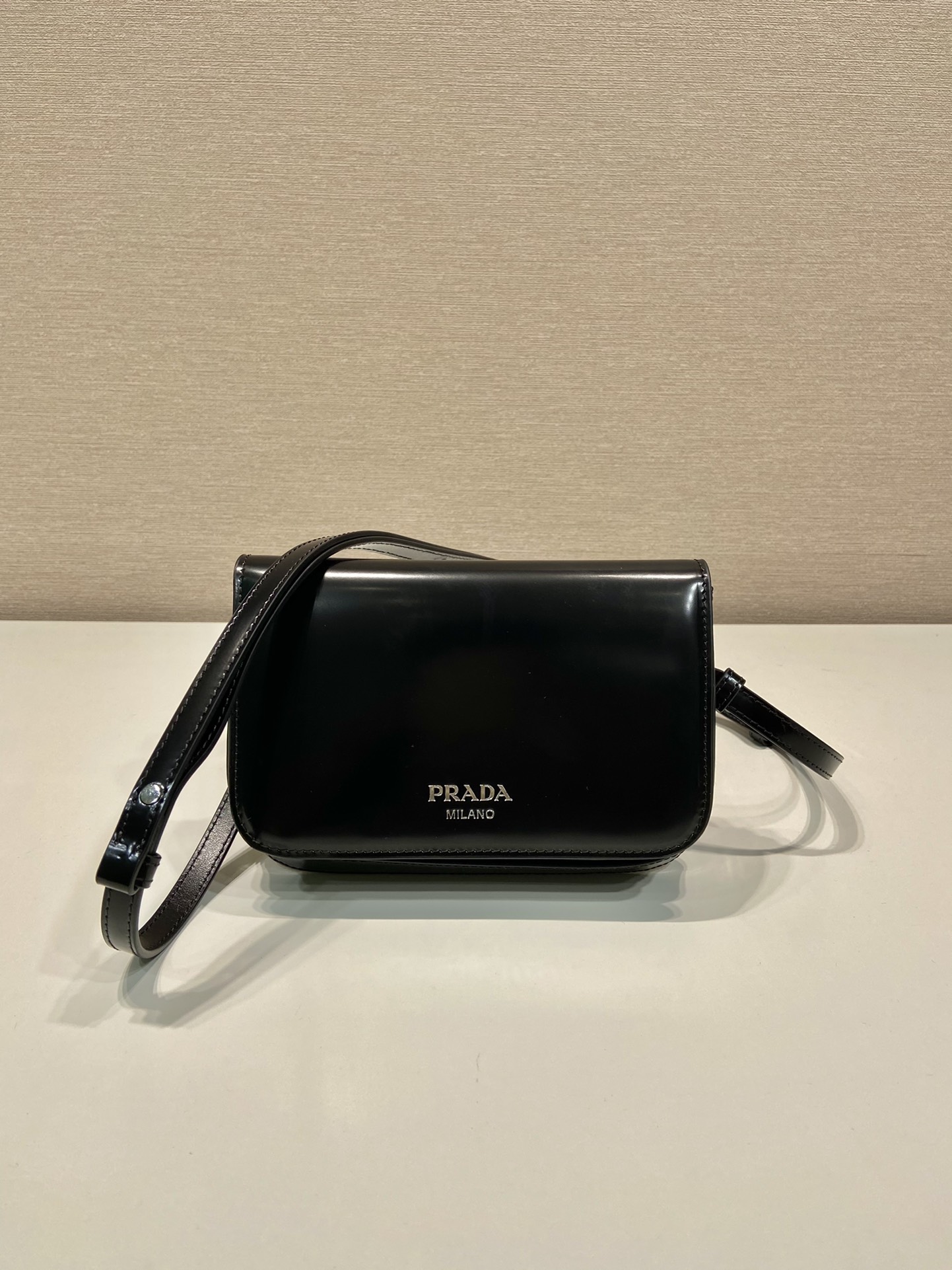 Pra*a brushed leather mini-bag with shoulder strap