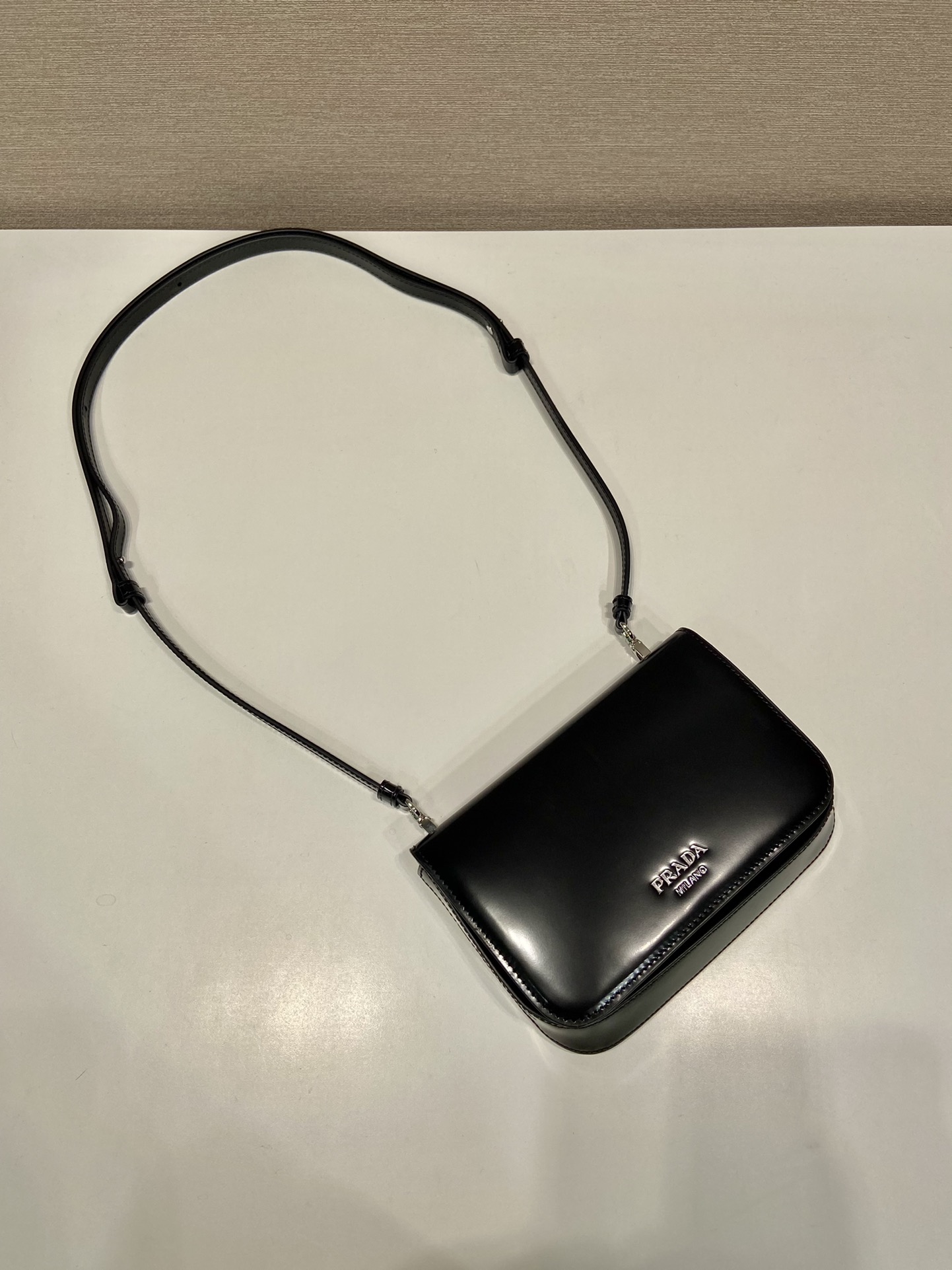 Pra*a brushed leather mini-bag with shoulder strap