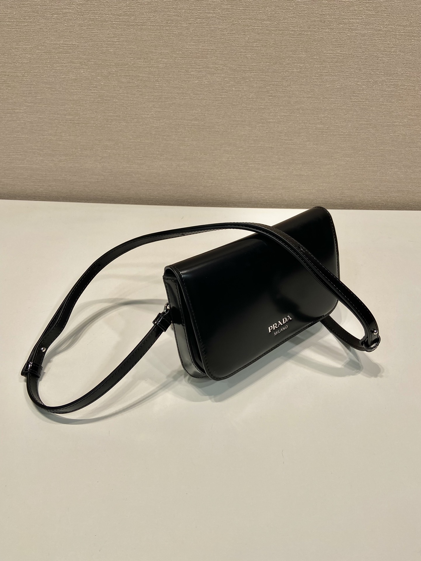 Pra*a brushed leather mini-bag with shoulder strap