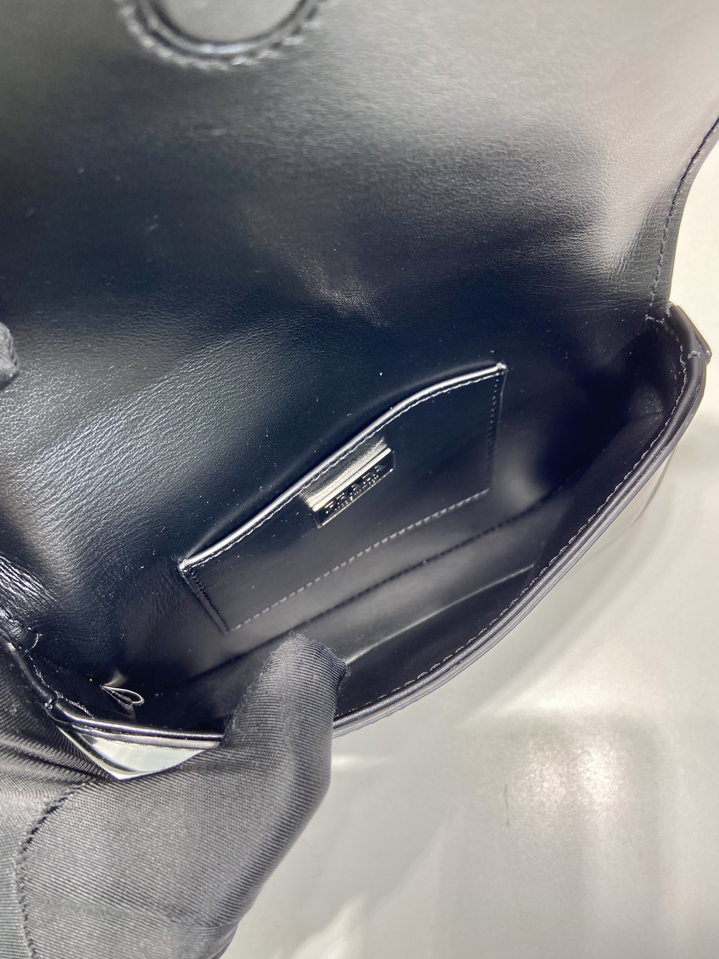 Pra*a brushed leather mini-bag with shoulder strap