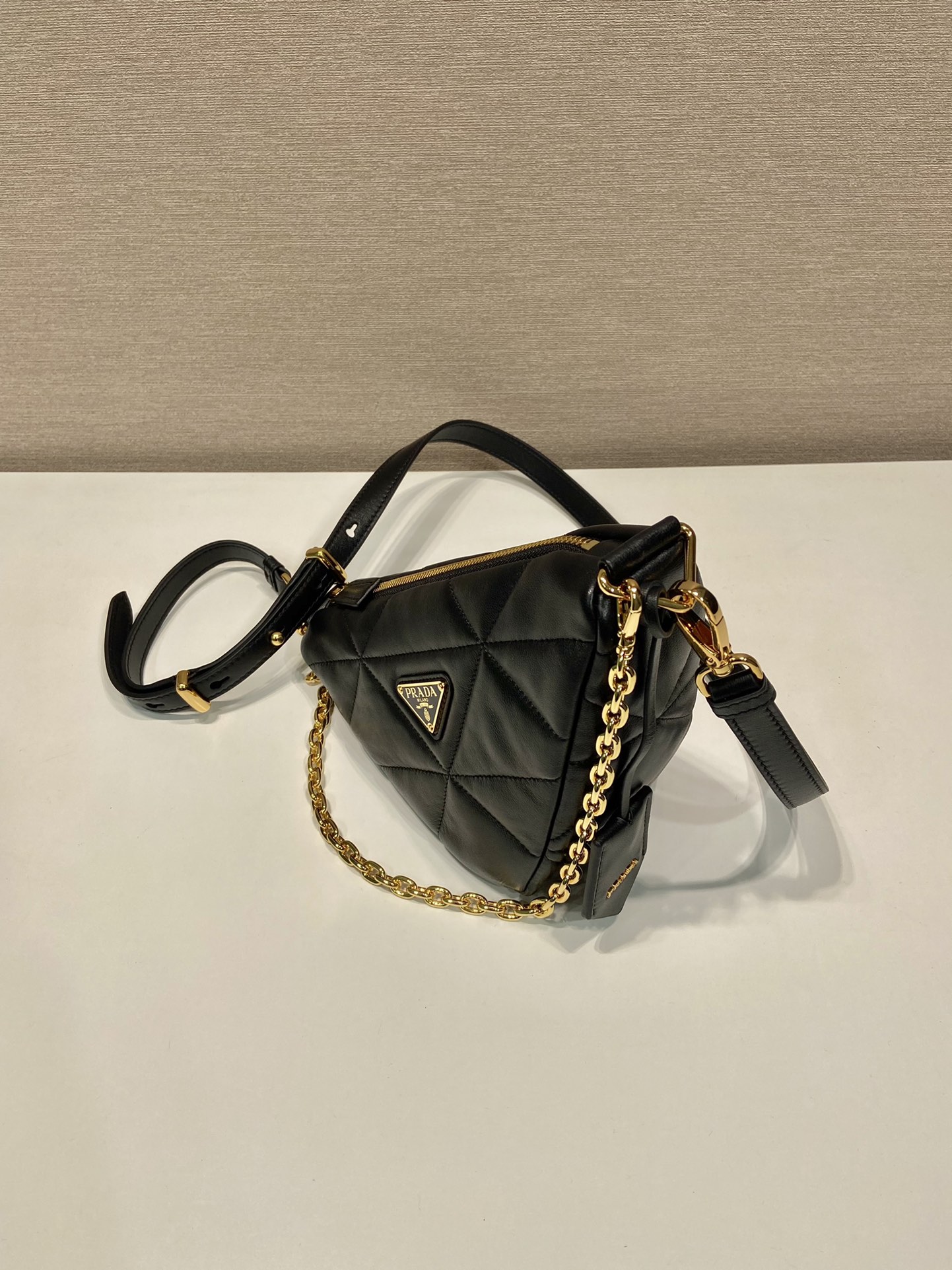 Pra*a triangle leather shoulder bag