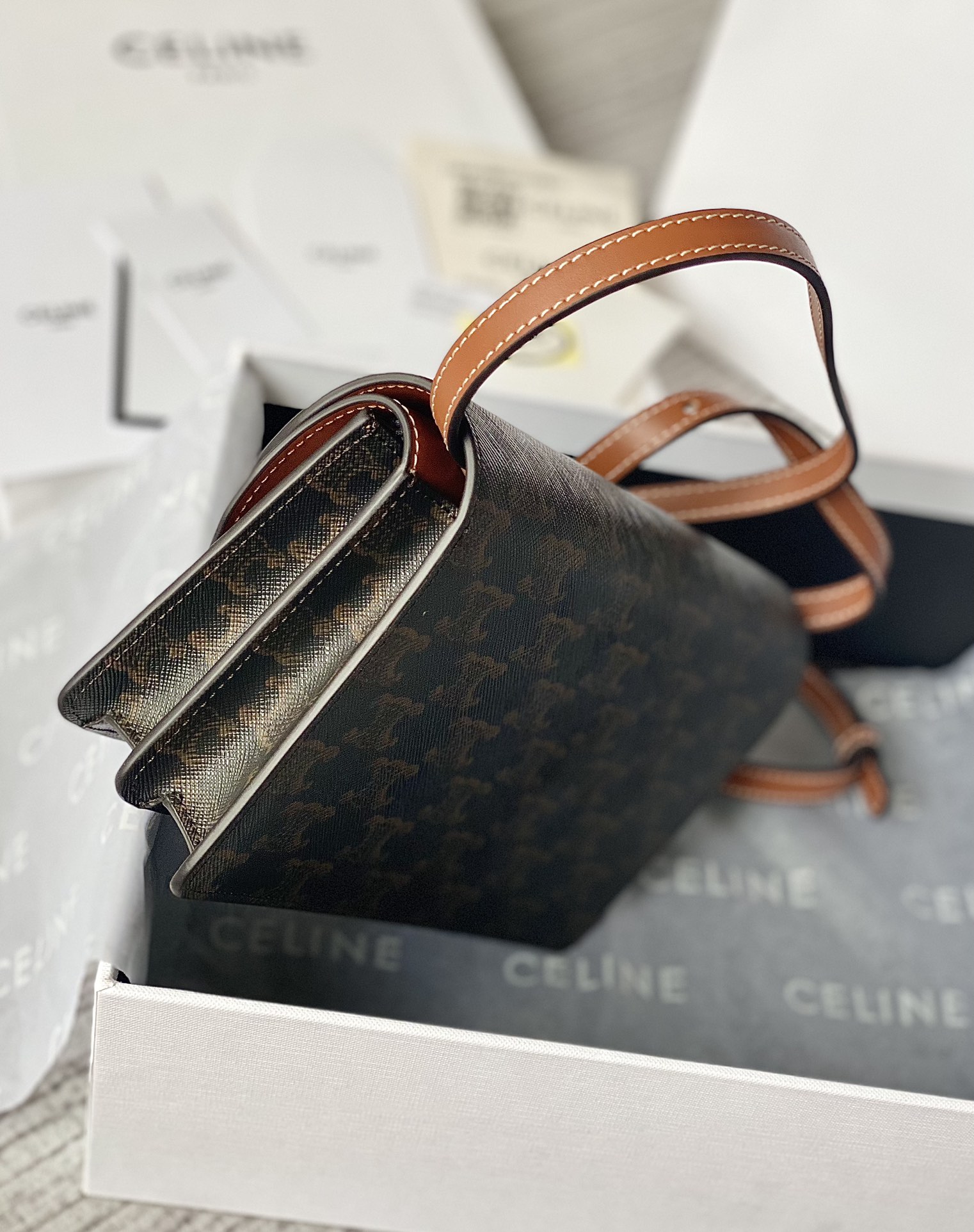 Ce**e wallet on strap in triomphe canvas and smooth lambskin tan