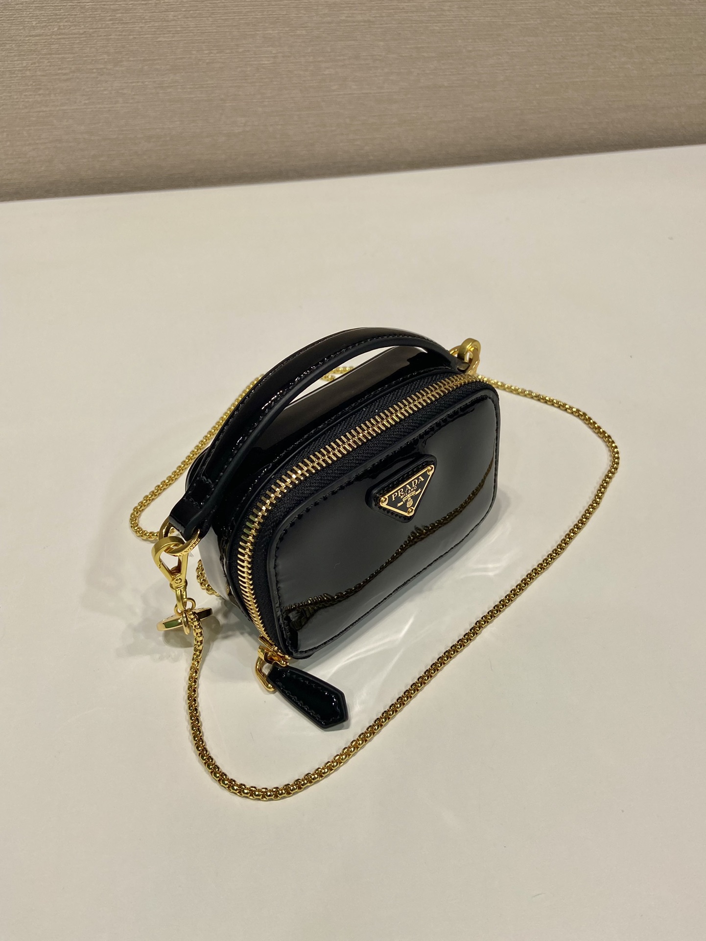 Pra*a patent leather mini-pouch
