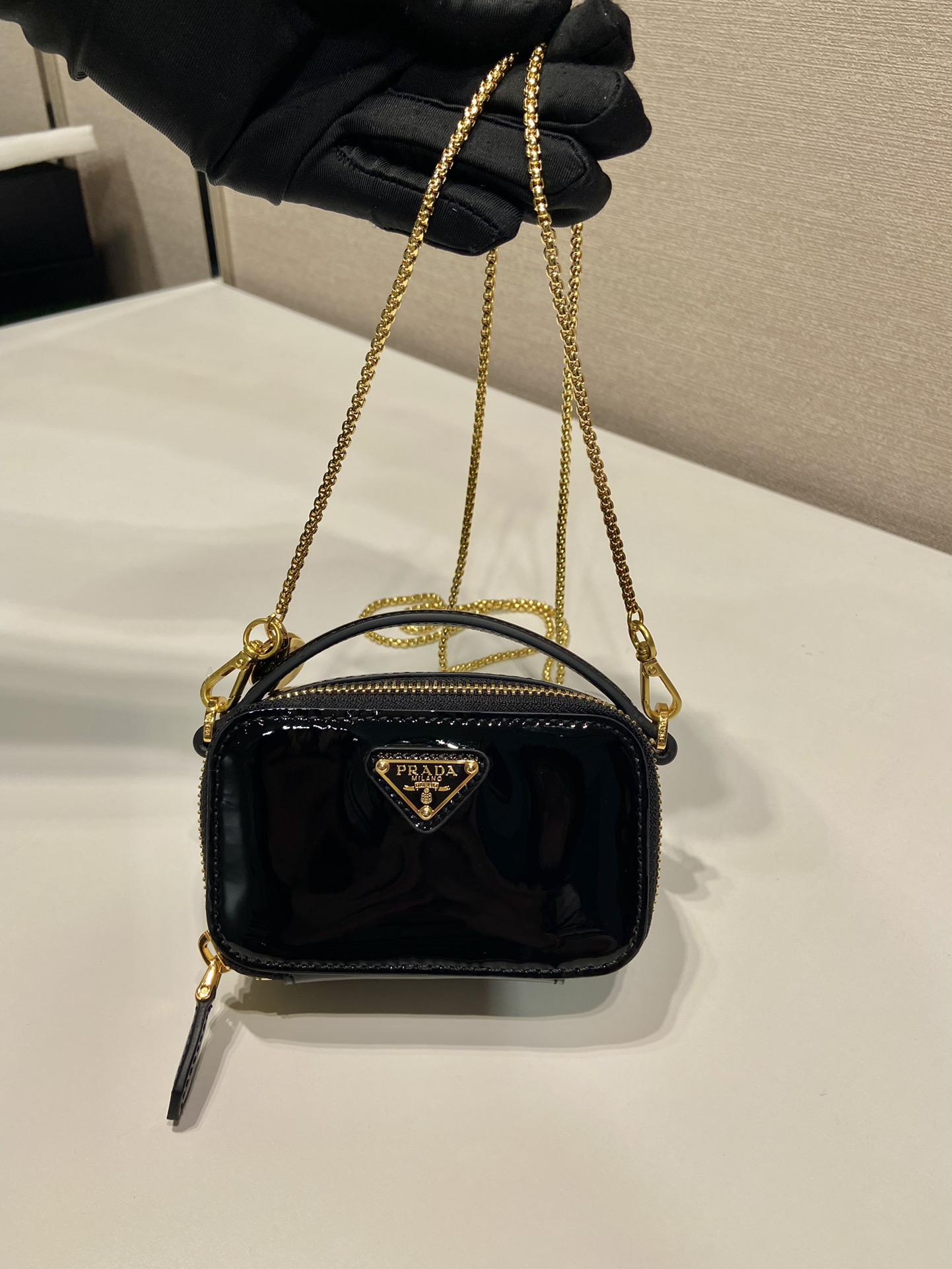 Pra*a patent leather mini-pouch