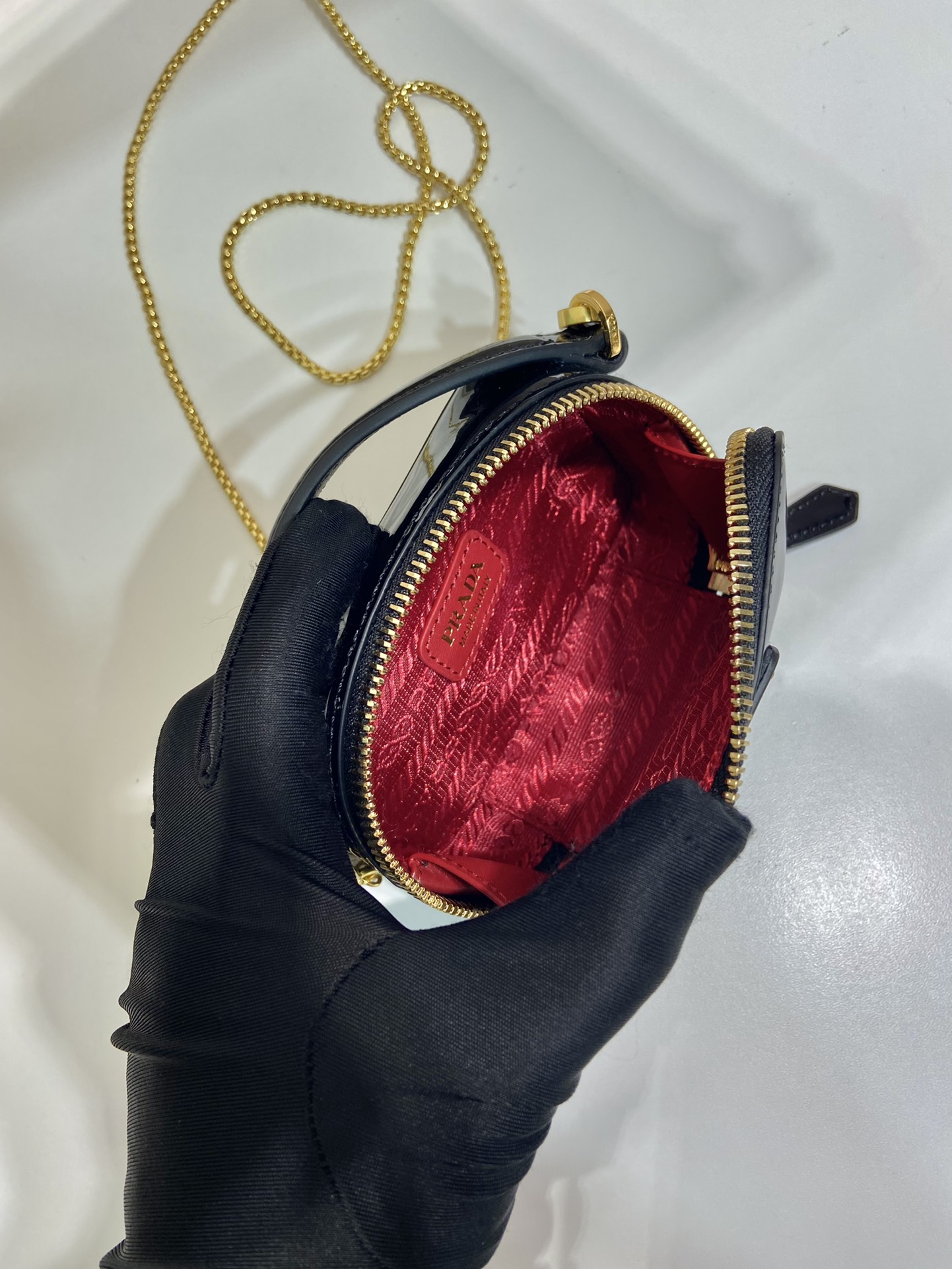Pra*a patent leather mini-pouch