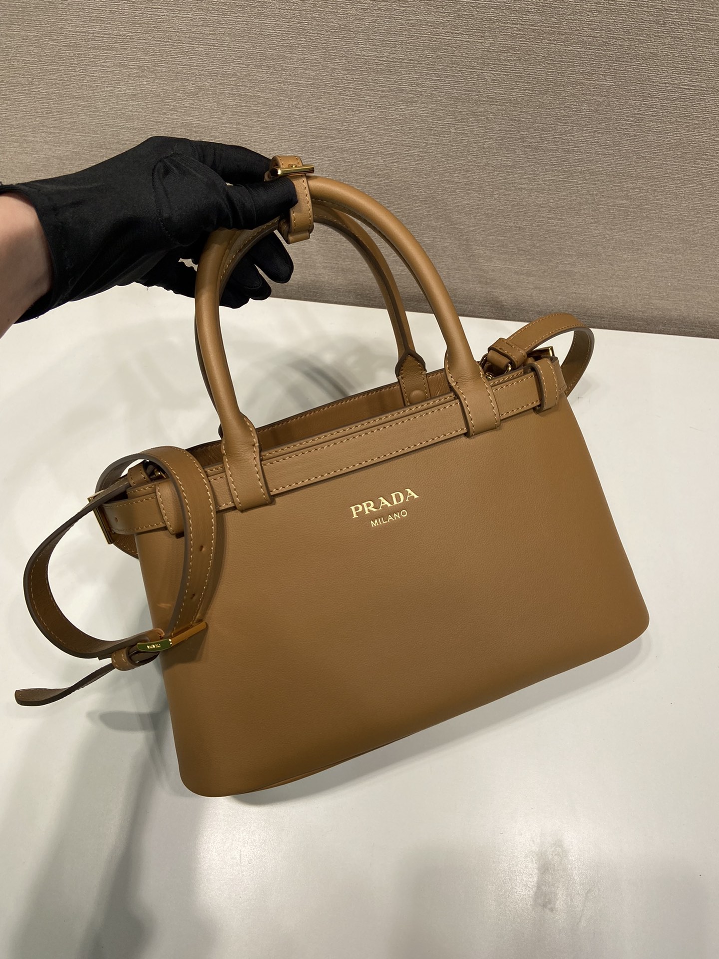 Pra*a buckle small leather handbag with double belt