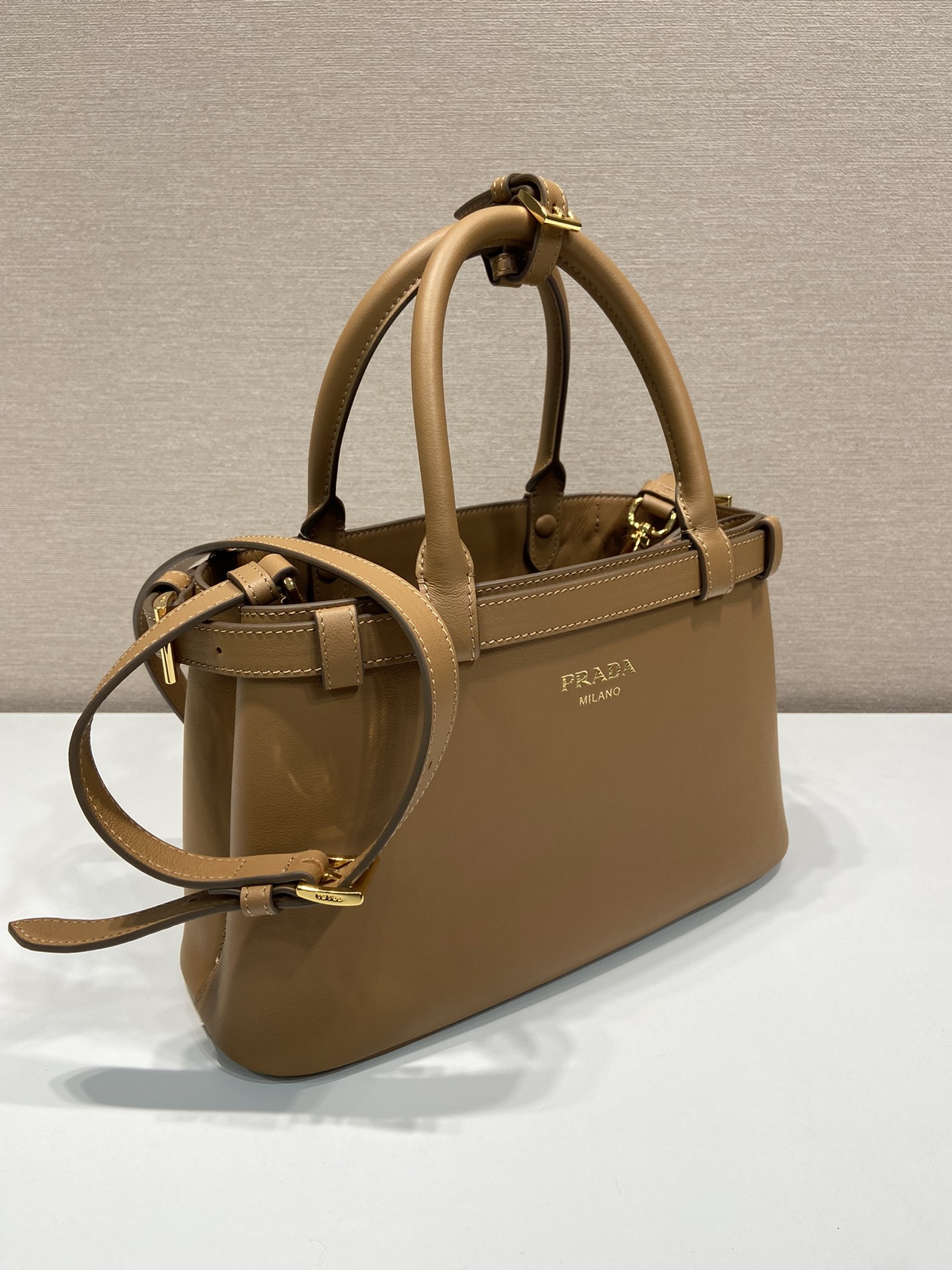 Pra*a buckle small leather handbag with double belt