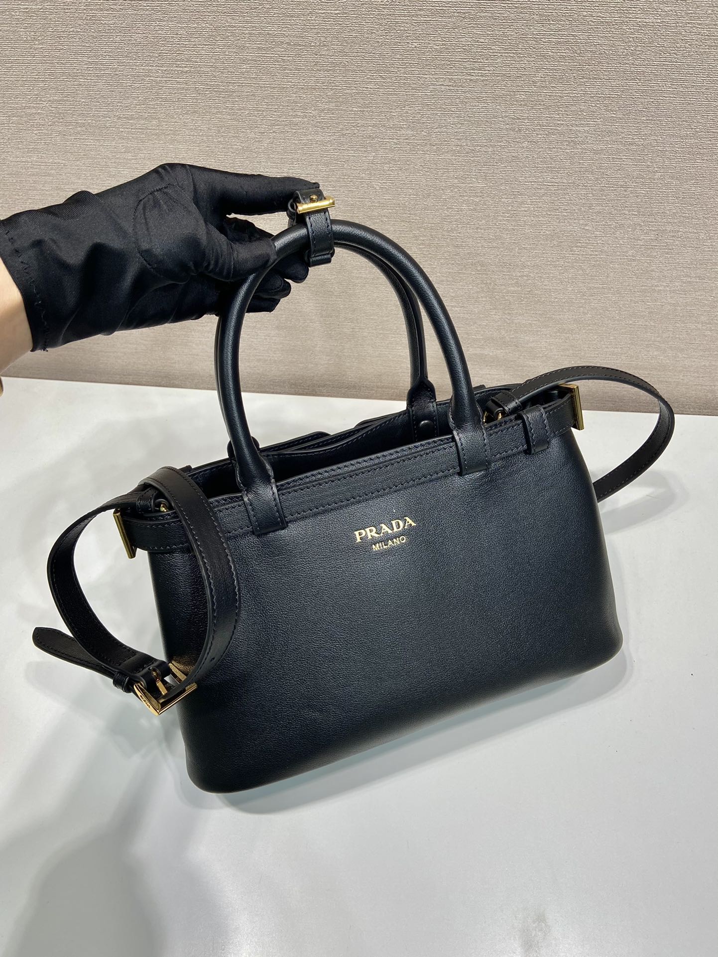 Pra*a buckle small leather handbag with double belt