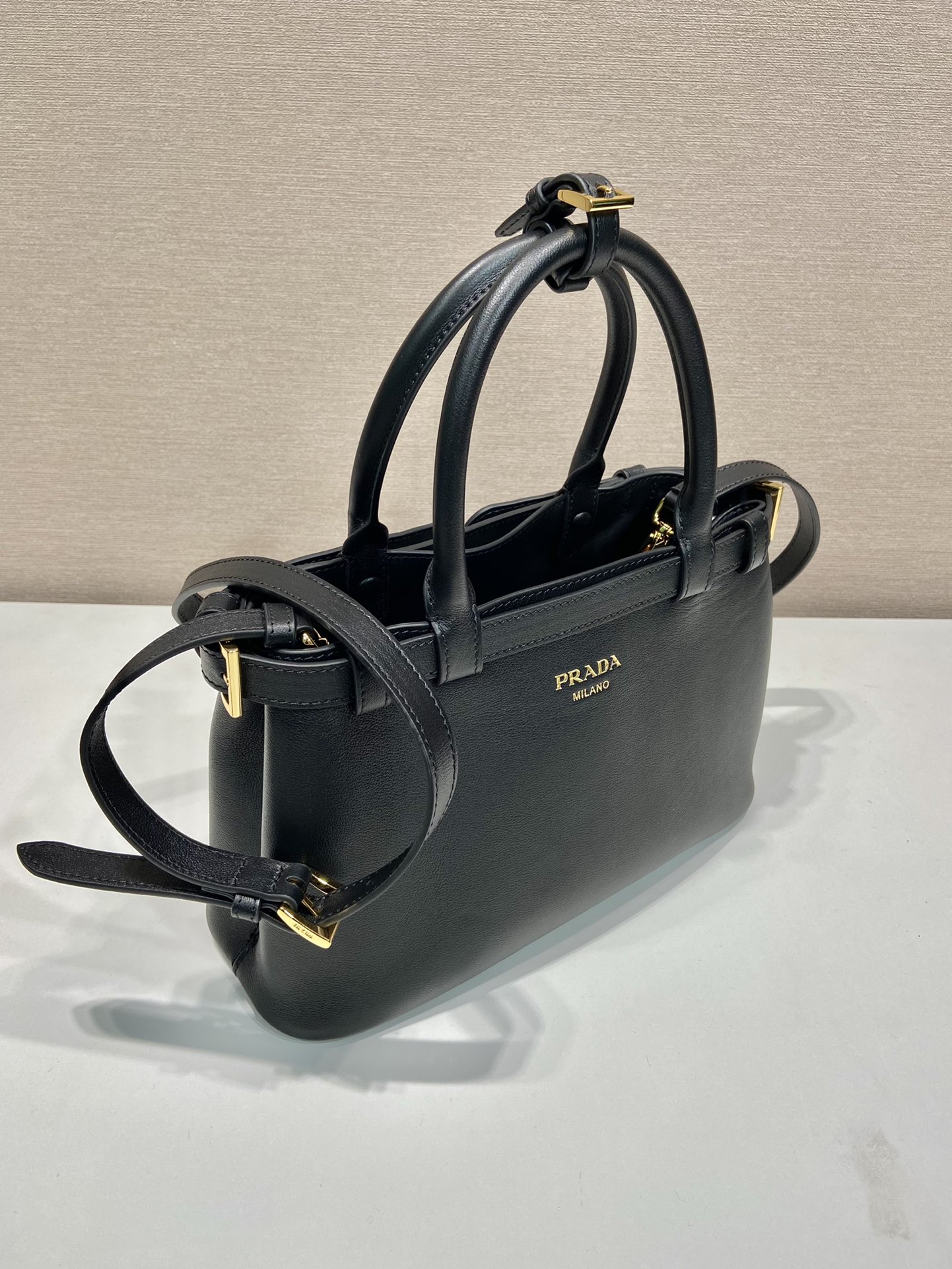 Pra*a buckle small leather handbag with double belt