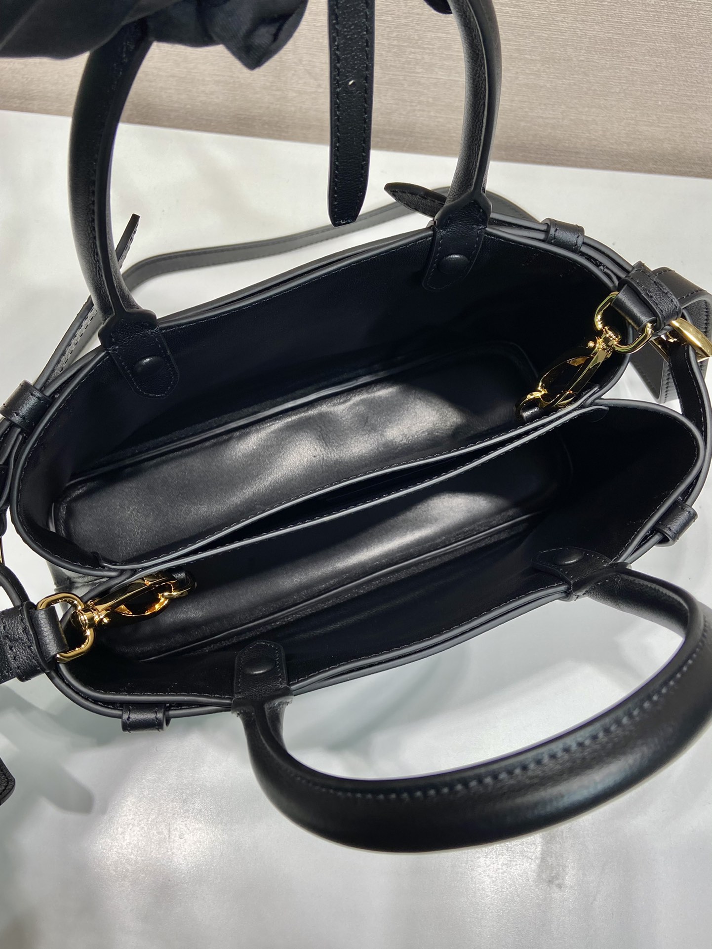 Pra*a buckle small leather handbag with double belt