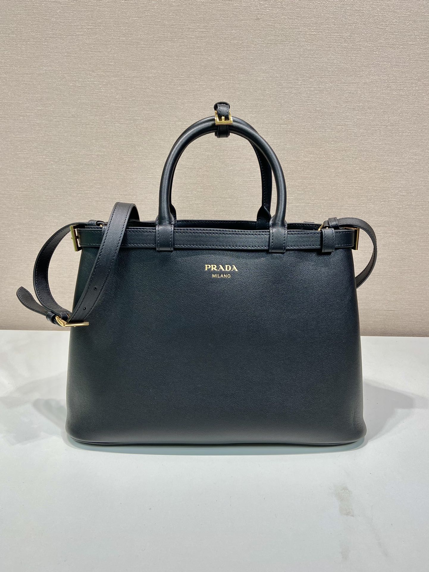 Pra*a buckle medium leather handbag with double belt
