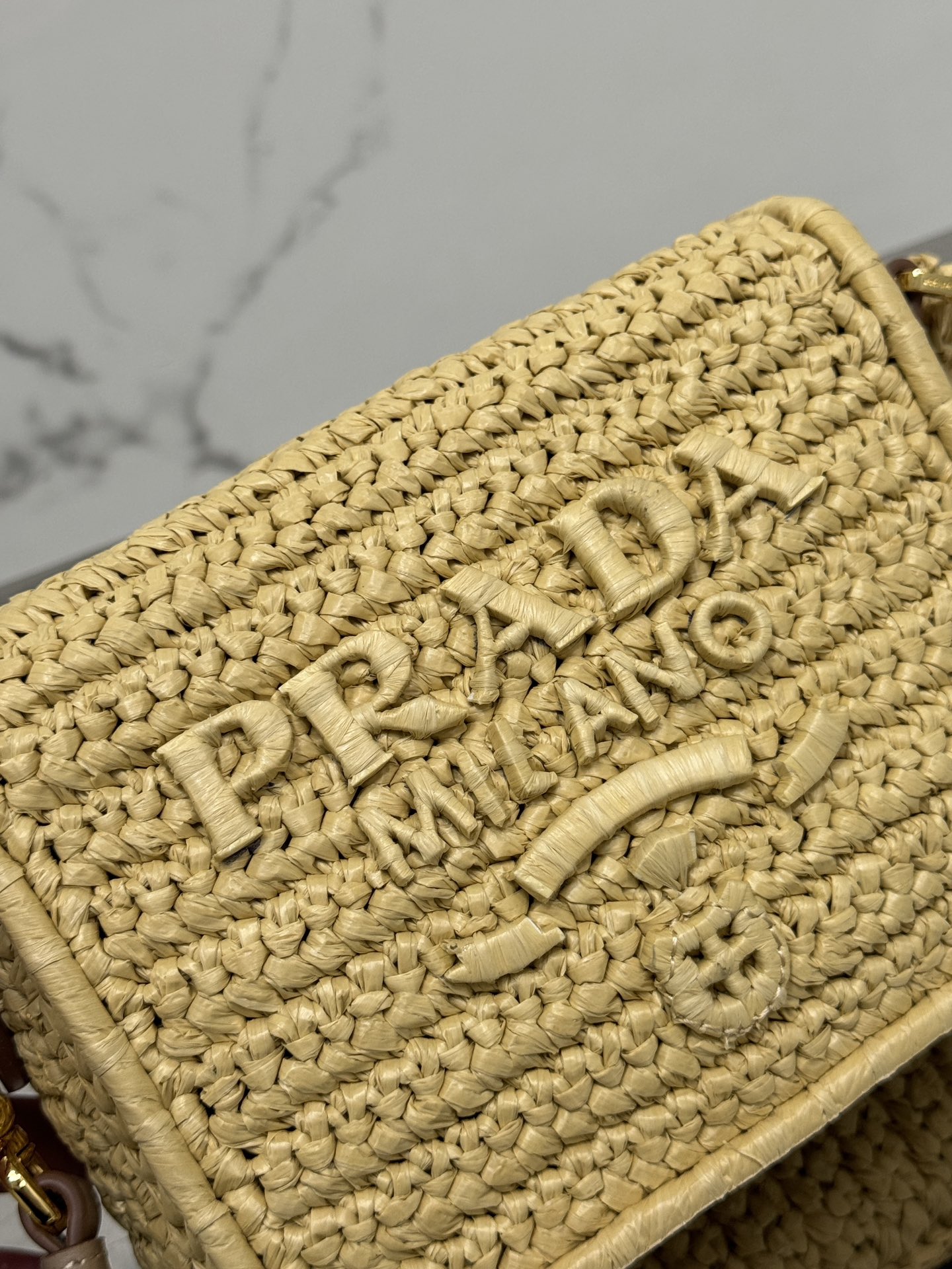 Pra*a crochet and leather shoulder bag with flap